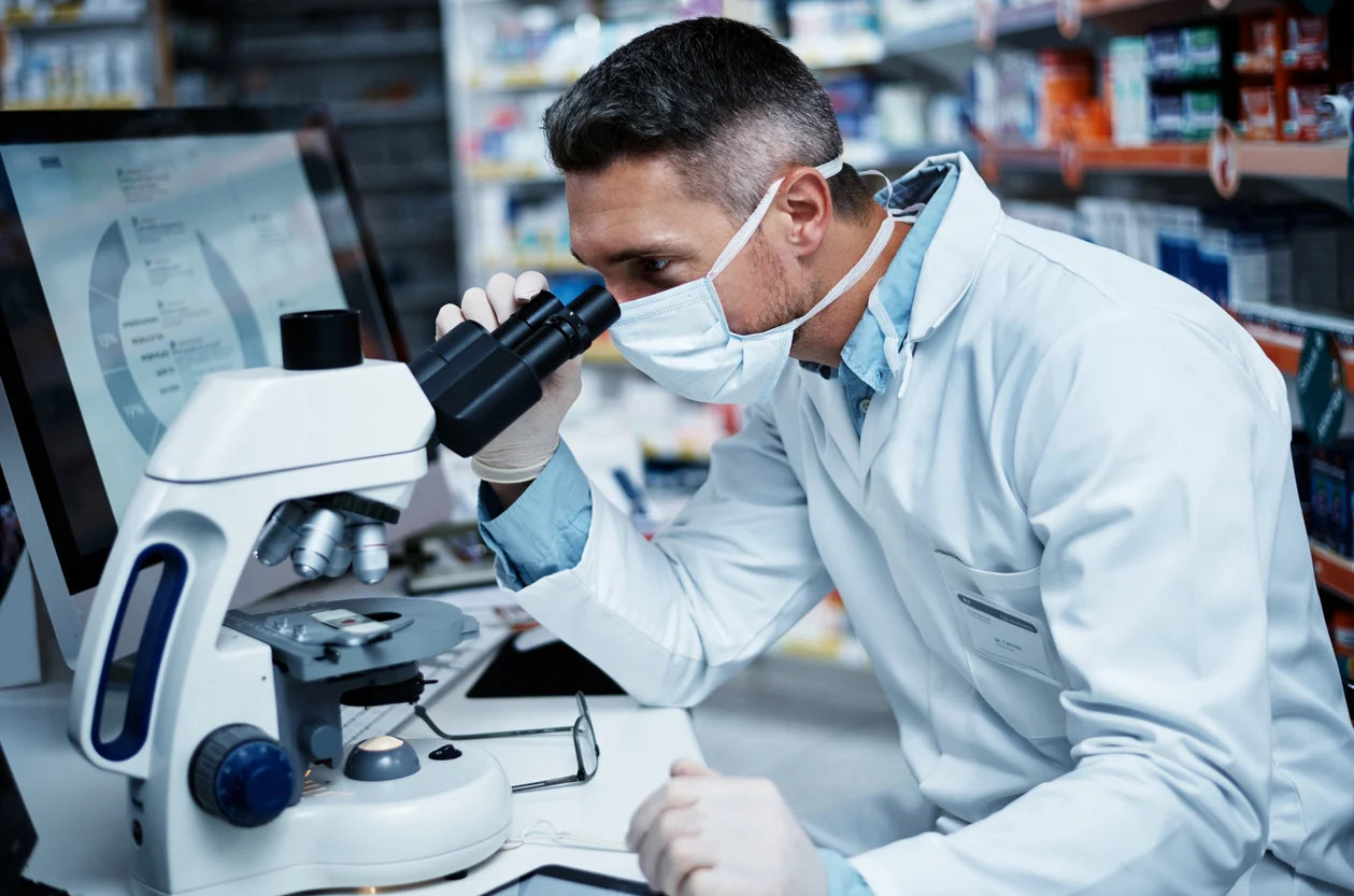 Man looking through microscope