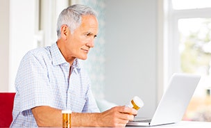 Man checking prescriptions on laptop